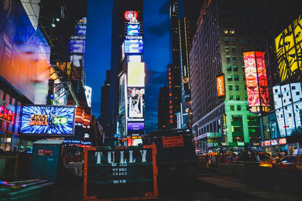 An iconic view of Times Square, New York City, illuminated with colorful lights and billboards at night.